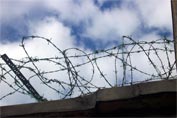 Coils of barbed wire against a cloudy sky